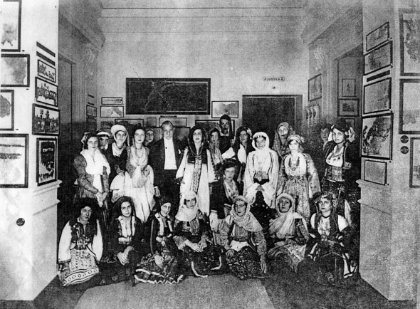 Antonis Benakis with a circle of women in traditional dress in the Benaki Museum, probably from the 1930s.  Benaki Museum.